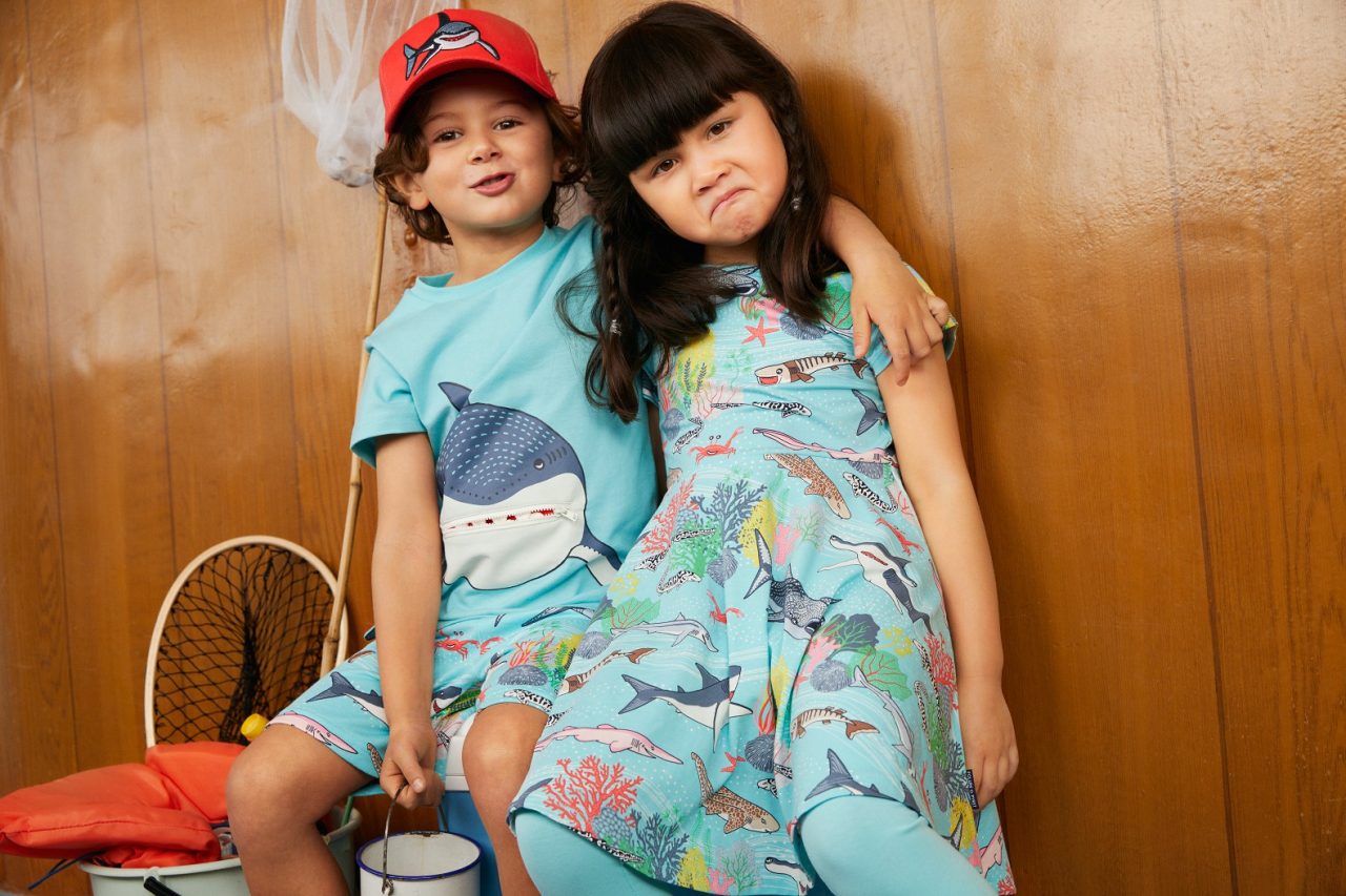 Two children wearing blue animals in the sea clothing