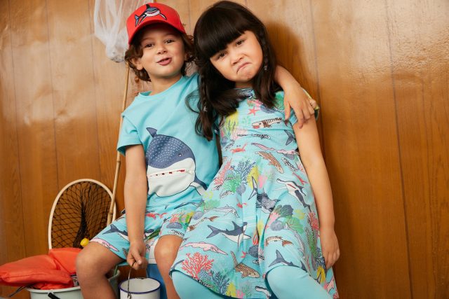 Two children wearing blue animals in the sea clothing