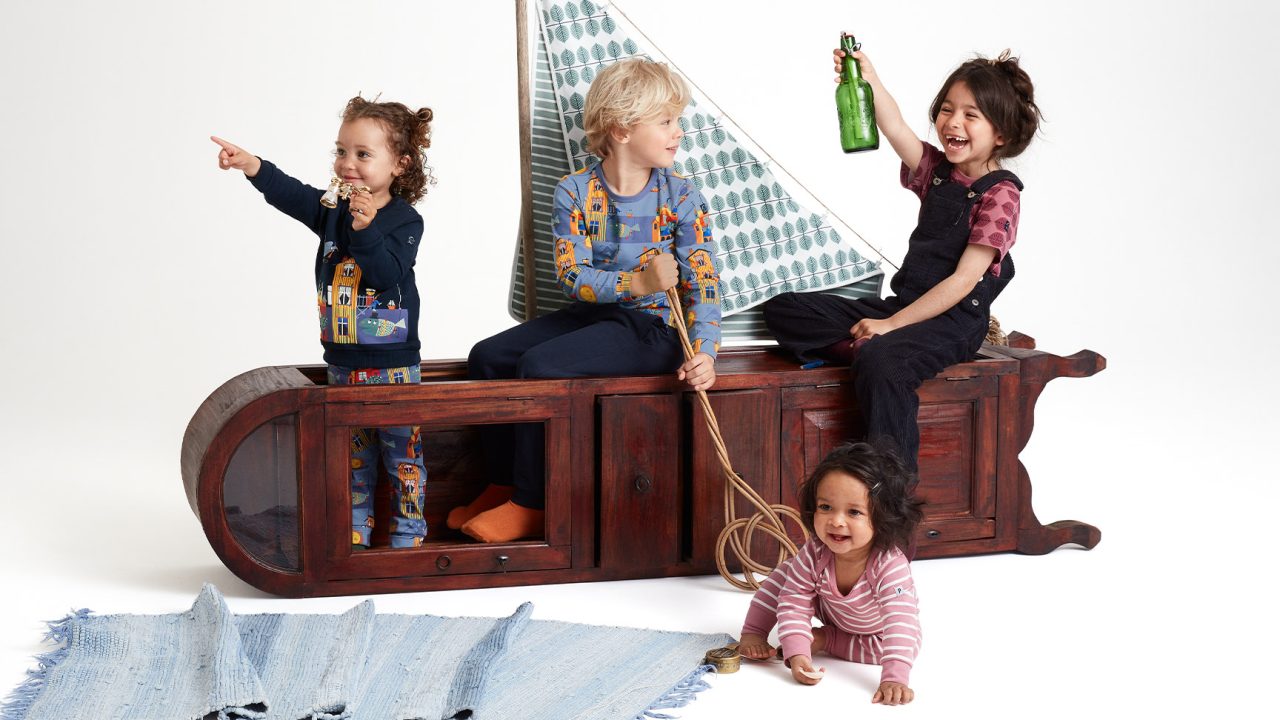 Four children wearing PO.P x Stig Lindberg clothing