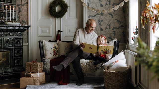 Man reading a book for a child